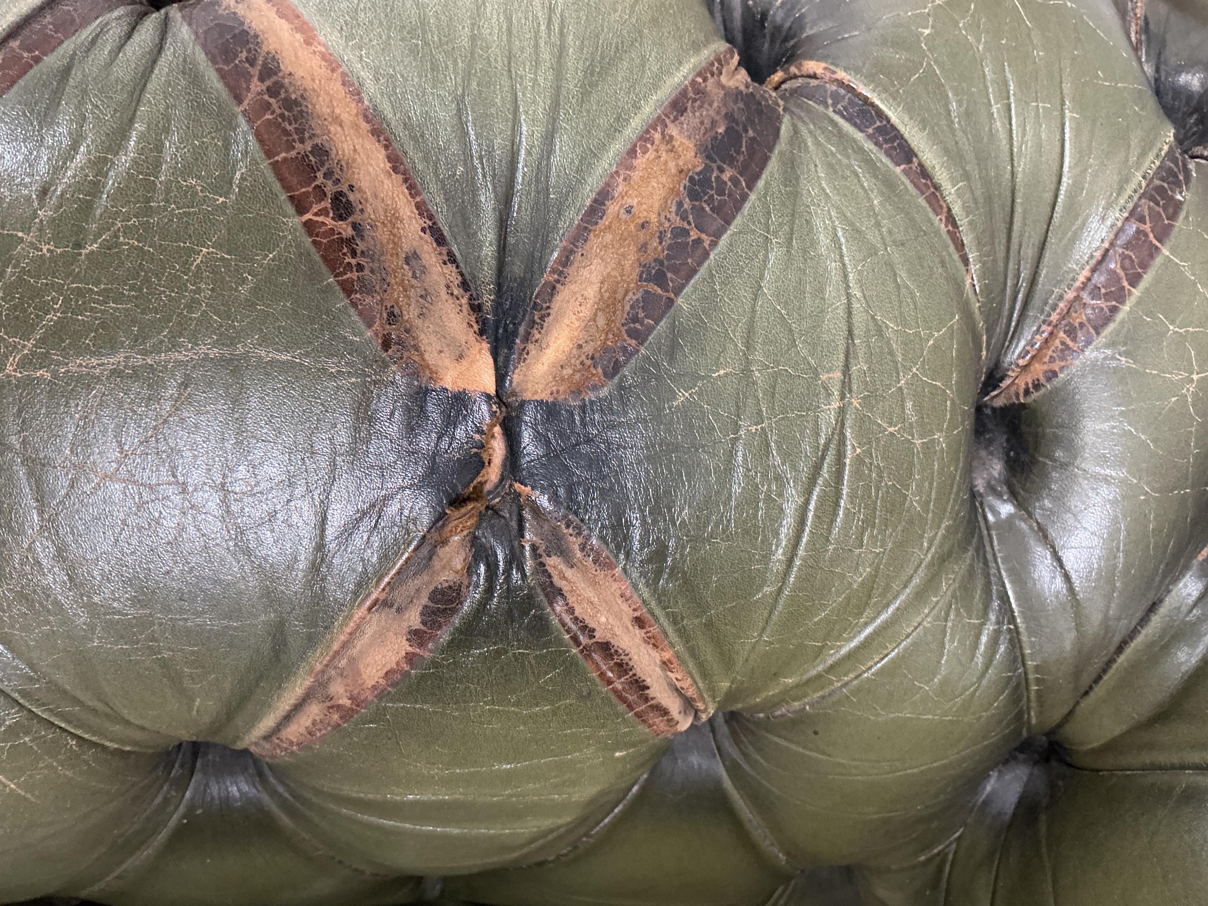 A pair of Chesterfield style buttoned green leather club armchairs, width 104cm, depth 92cm, height 74cm